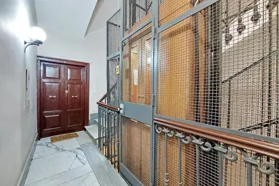 a hallway with a gate and a wooden door at 4BNB - Ripetta Central Apartment in Rome