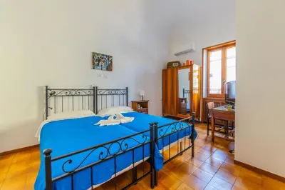 a bedroom with a blue bed in a room at Villa Gatta in Rome
