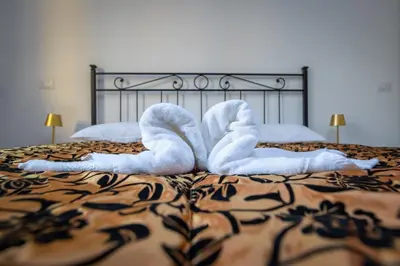 a bed with white towels on top of it at Villa Gatta in Rome