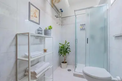 a bathroom with a glass shower and a toilet at Villa Gatta in Rome