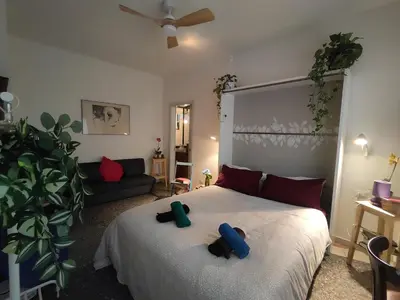 a bedroom with a bed with a teddy bear on it at That's Theatre House, near the Colosseum! in Rome