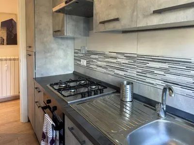 a kitchen with a stove and a sink at JHHIT Tuscolana Suite 01 with Terrace in Rome
