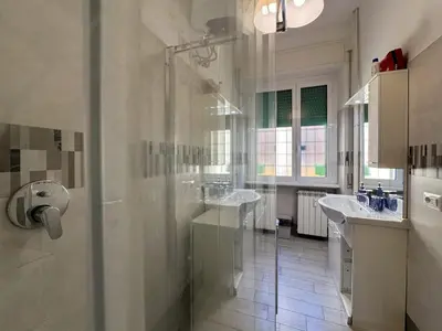 a bathroom with two sinks and a shower at JHHIT Tuscolana Suite 01 with Terrace in Rome