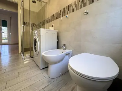 a bathroom with a toilet and a sink and a shower at JHHIT Tuscolana Suite 01 with Terrace in Rome