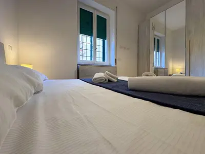 a large white bed in a room with a mirror at JHHIT Tuscolana Suite 01 with Terrace in Rome