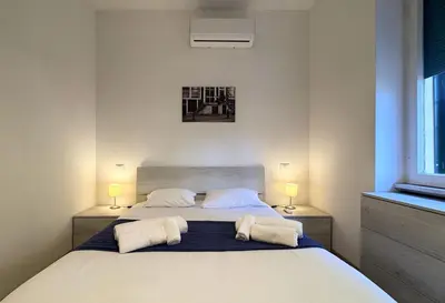 a bedroom with a large white bed with two pillows at JHHIT Tuscolana Suite 01 with Terrace in Rome