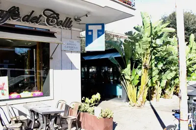 a restaurant with tables and chairs in front of a building at New Green Hill Apartment - Colli Portuensi in Rome