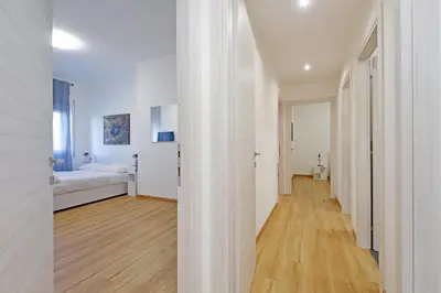 a white room with a bed and a hallway at 4BNB - Baldo degli Ubaldi Big Apartment in Rome