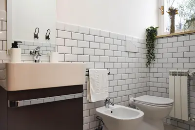 a white bathroom with a sink and a toilet at St. Peter Sweets in Rome