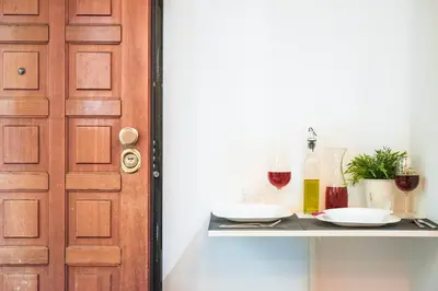 a table with two glasses of wine and a door at St. Peter Sweets in Rome