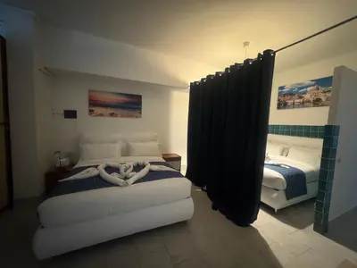 a bedroom with two beds with black curtains at Munsi guest house in Rome