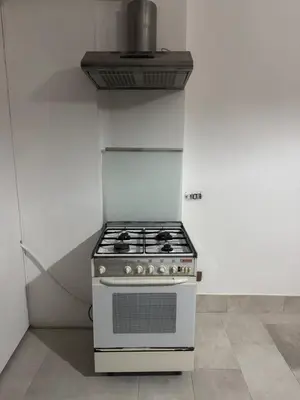 a white stove in a kitchen with a hood at Munsi guest house in Rome
