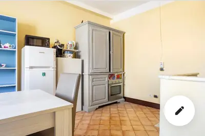 a kitchen with a refrigerator and a table in it at 3C Domus St Peter Roma Centro 