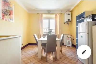 a kitchen and dining room with a table and chairs at 3C Domus St Peter Roma Centro 