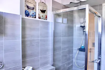 a shower with a glass door in a bathroom at HC - Richetta's Comfy House near the Vatican in Rome