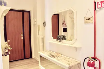 a room with a table and a mirror and a door at HC - Richetta's Comfy House near the Vatican in Rome