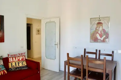 a living room with a table and a red couch at HC - Richetta's Comfy House near the Vatican in Rome