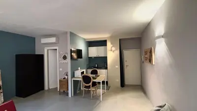 a living room with a table and a kitchen at La casa di zoe in Rome