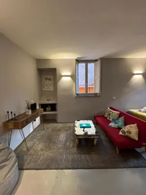 a living room with a red couch and a table at La casa di zoe in Rome