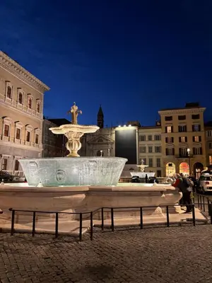 a fountain in the middle of a city at night at La casa di zoe in Rome