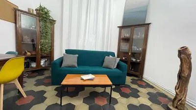 a living room with a blue couch and a table at Da Naya all' Appia Antica in Rome
