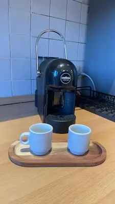 two cups on a cutting board next to a toaster at Da Naya all' Appia Antica in Rome