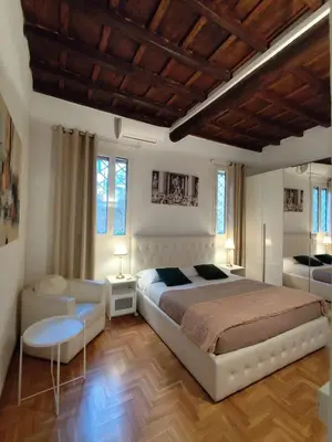 a bedroom with a large bed and a couch at Bijoux de Rome Navona Luxury Apartment in Rome
