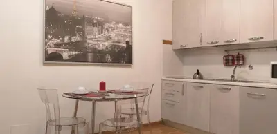 a kitchen with a table and some chairs in it at Bijoux de Rome Navona Luxury Apartment in Rome