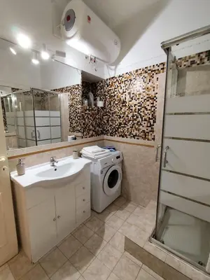 a bathroom with a washing machine and a sink at Bijoux de Rome Navona Luxury Apartment in Rome