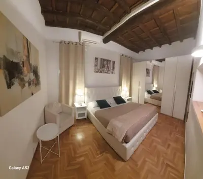 a bedroom with a bed and a chair in it at Bijoux de Rome Navona Luxury Apartment in Rome