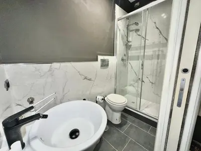a bathroom with a sink and a shower and a toilet at Xcross Suites Garbatella in Garbatella