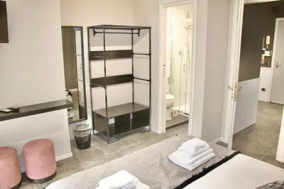 a room with a bathroom with a toilet and a mirror at Xcross Suites Garbatella in Garbatella