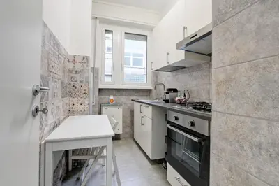 a small kitchen with a stove and a sink at Vatican's Apartment in Rome