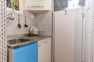 a small kitchen with a sink and a refrigerator at Elegantis Monti Suite Apartment in Rome