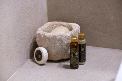 two bottles of essential oils sitting on a bathroom floor at Elegantis Monti Suite Apartment in Rome