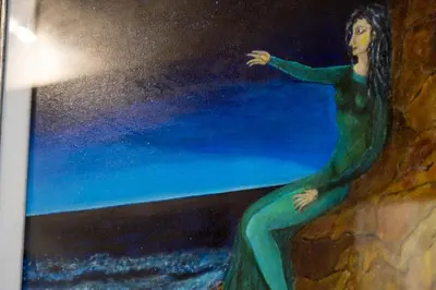 a painting of a woman sitting on a wall at Elegantis Monti Suite Apartment in Rome
