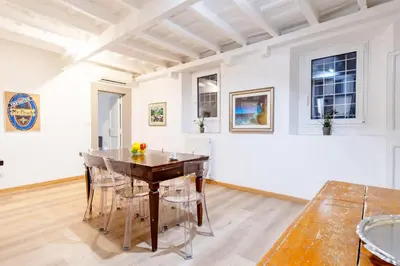 a dining room with a wooden table and chairs at Elegantis Monti Suite Apartment in Rome
