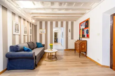 a living room with a blue couch and a table at Elegantis Monti Suite Apartment in Rome