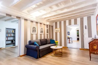 a living room with a blue couch and a table at Elegantis Monti Suite Apartment in Rome