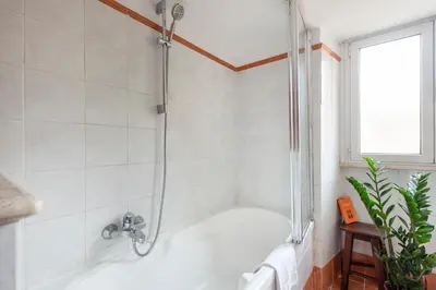 a bathroom with a shower with a tub at Bright Loft Rome City Center in Rome