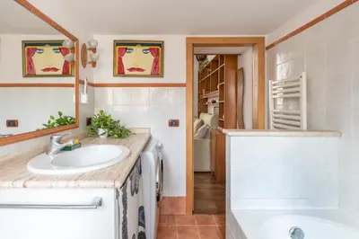 a bathroom with a sink and a tub at Bright Loft Rome City Center in Rome