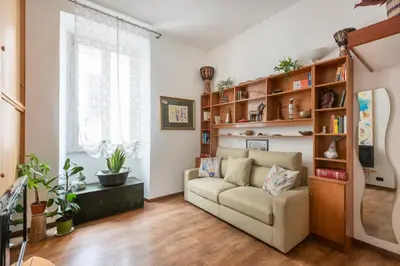 a living room with a couch and shelves at Bright Loft Rome City Center in Rome