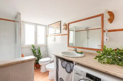a bathroom with a sink and a toilet and a mirror at Bright Loft Rome City Center in Rome