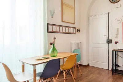 a dining room table with chairs and a vase on it at Bright Loft Rome City Center in Rome