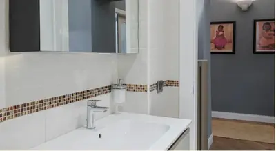 a white bathroom with a sink and a mirror at Vatican Rhapsody in Rome