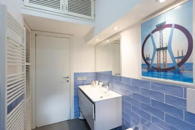 a bathroom with a sink and a mirror at Secret Terrace by Rental in Rome in Rome