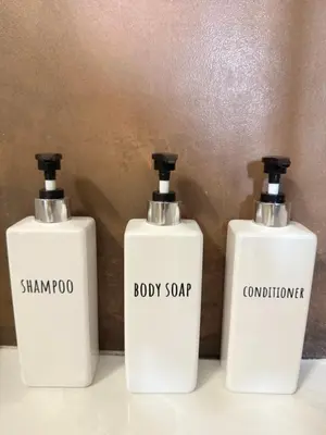 a couple of white soap bottles sitting on a counter at CardinalBaldo in Rome