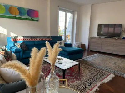 a living room with a blue couch and a table at CardinalBaldo in Rome