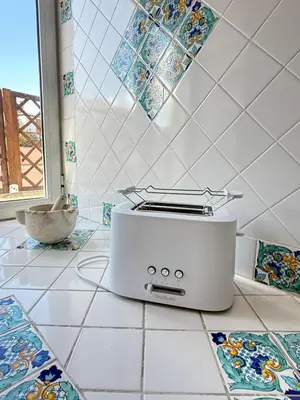 a toaster sitting on a kitchen counter with tiles at CardinalBaldo in Rome