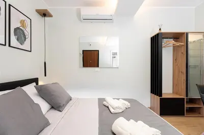 a bedroom with a bed with two towels on it at Suite Room Suriani in Rome